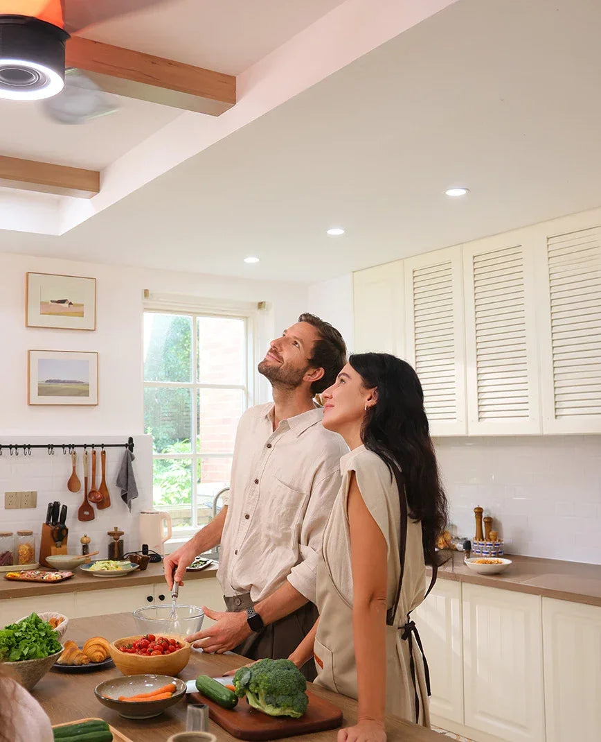 Ceiling fan with an integrated speaker system and built-in lighting in a bright kitchen.